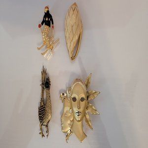 This is a lot of 4 pretty brooches. 1 Road Runner gold tone /green stone eye/sig